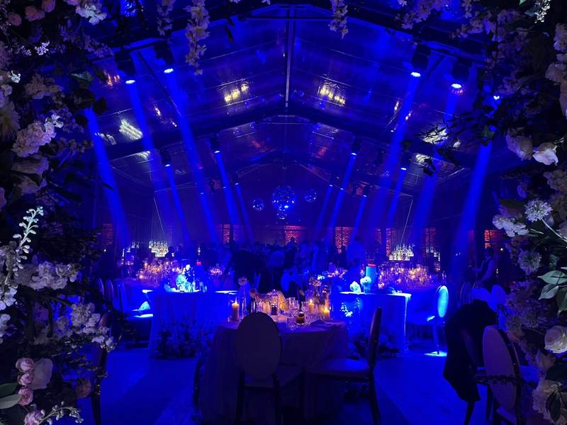 Blue lit interior with floral arch