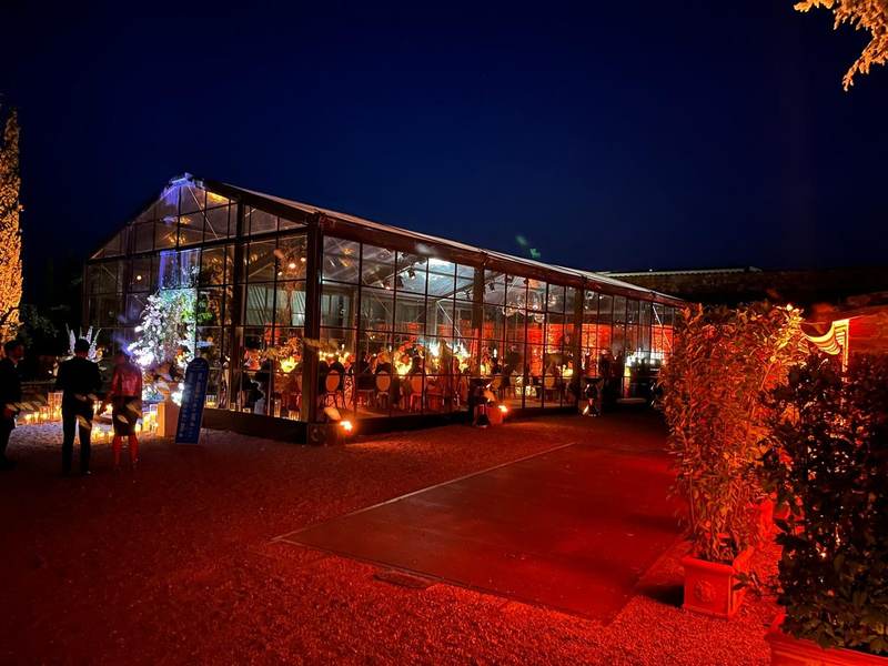Red lit greenhouse at night