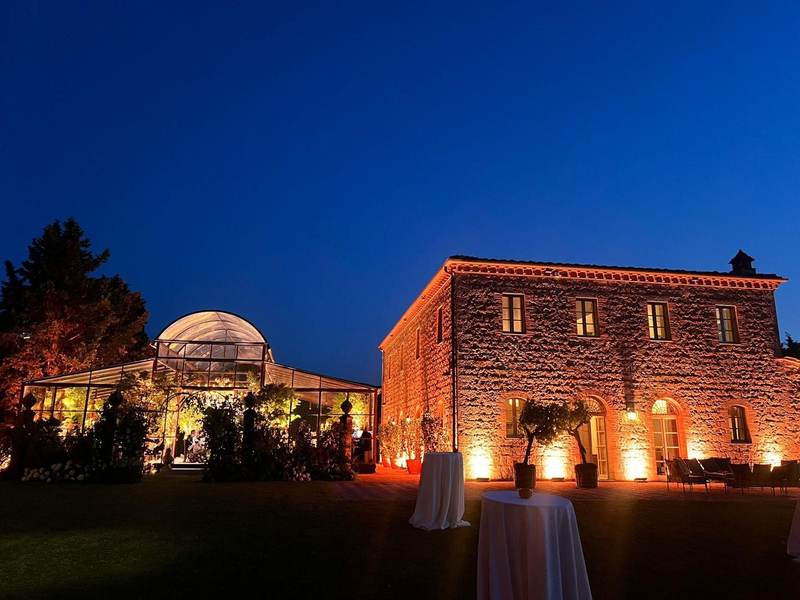 Villa and greenhouse lit at night