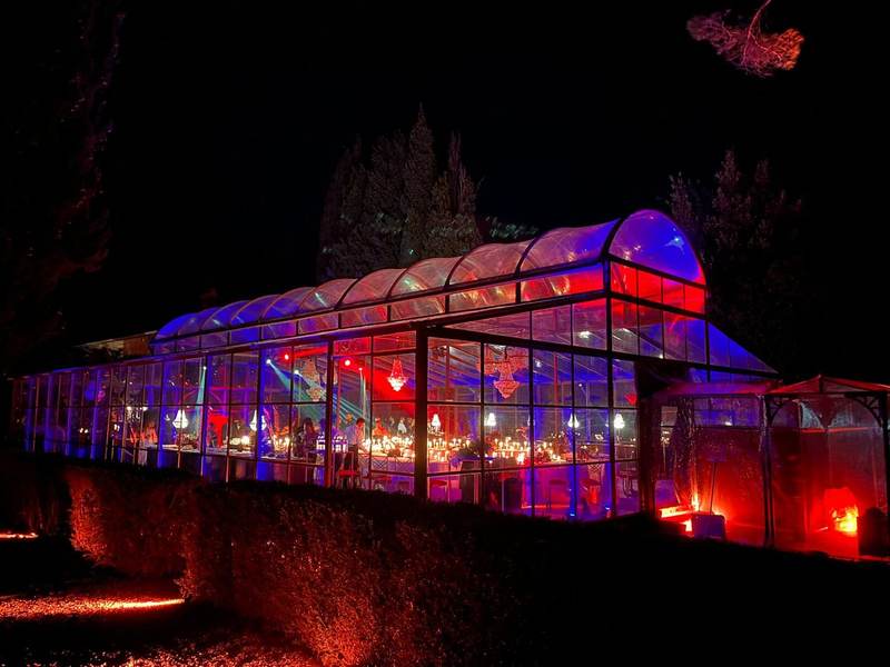 Greenhouse illuminated in red and blue at night