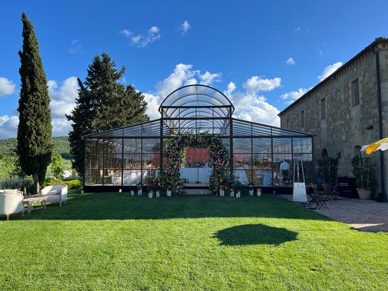Glass greenhouse structure with floral arch