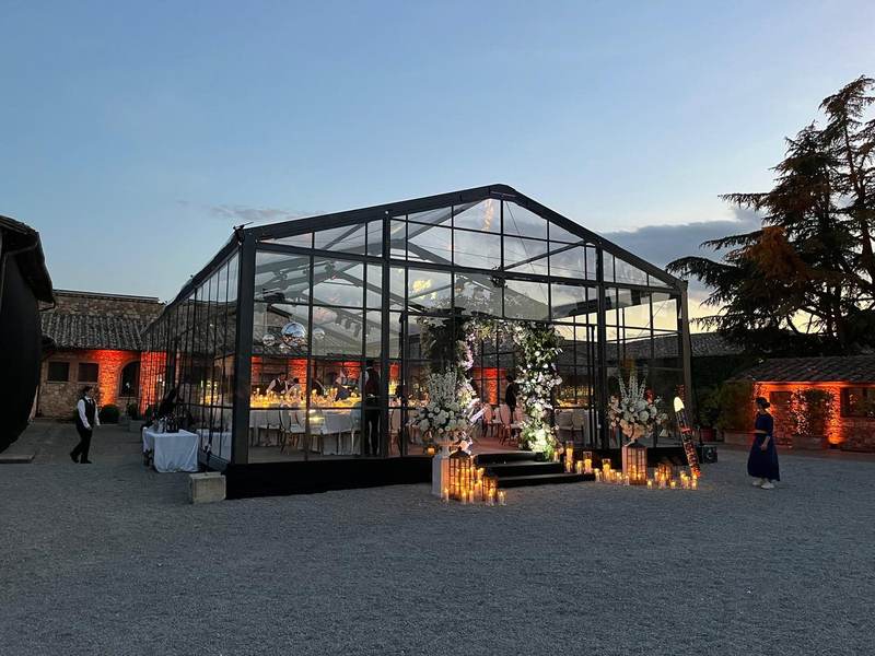 Glass structure at twilight with candles