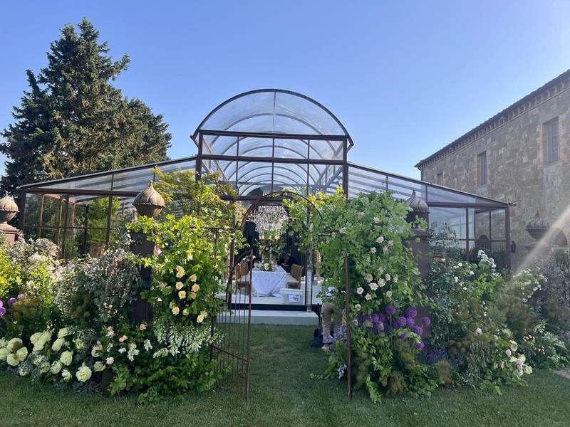 Greenhouse surrounded by flowers